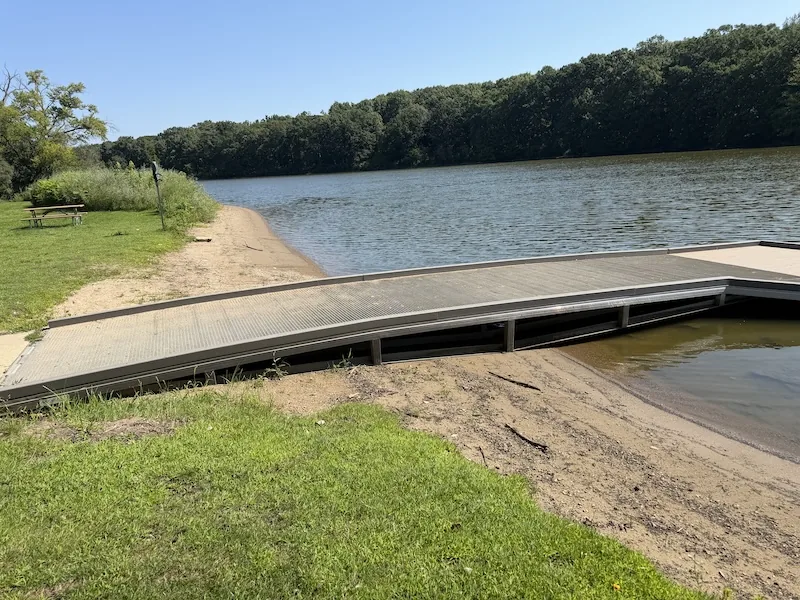 The paddlesports launch at Ferson Creek Park. The sandy shoreline immediately north of the floating dock is the practical canoe and kayak launch.