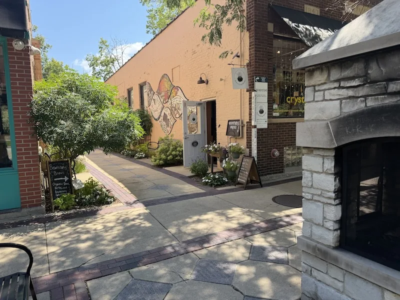 Garden-lined passage leading to Bewitching Brews in Geneva, Illinois