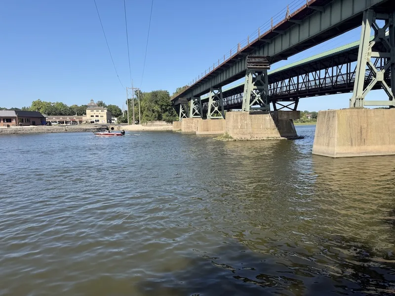 Multiple bridge pylons viewed from river level on the Fox River