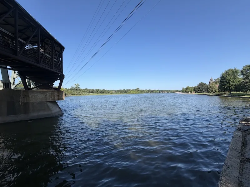 Bridge supports, shade and open river water in St. Charles